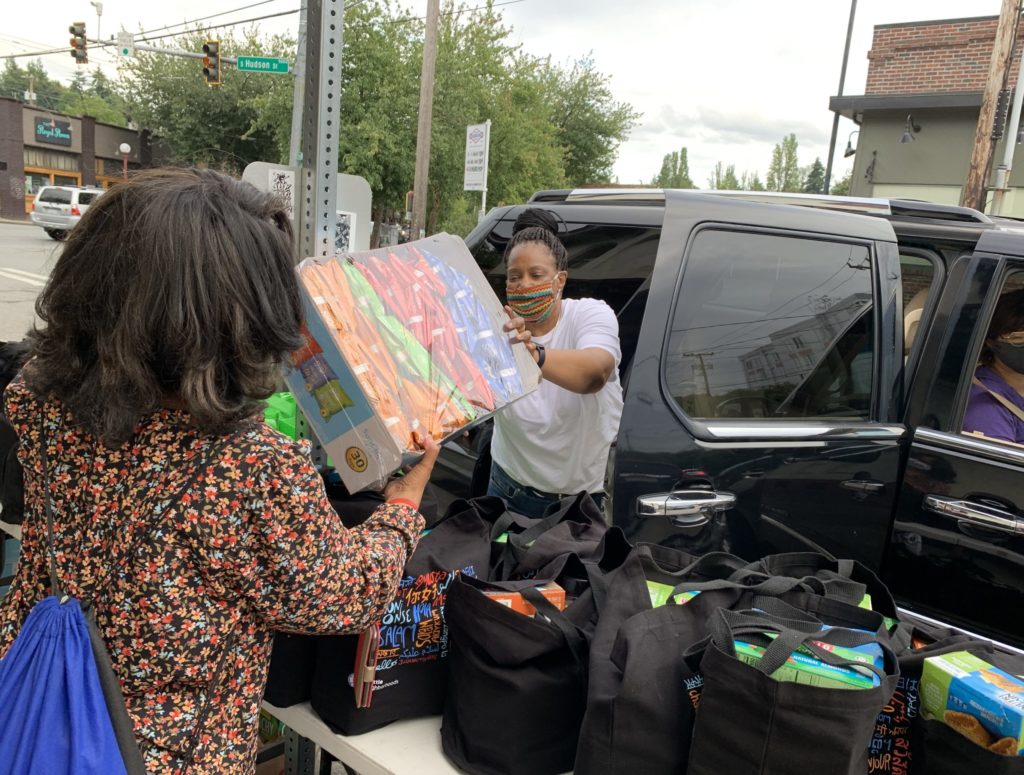 FAST volunteers load car with family care package