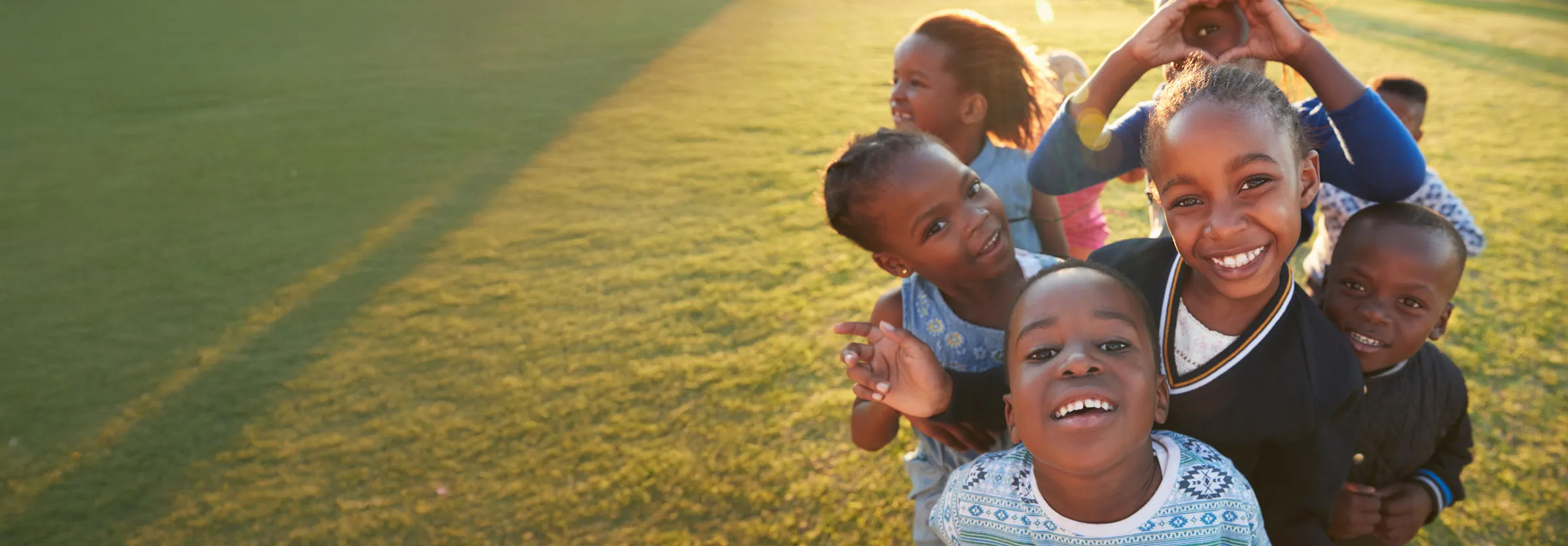 a group of children smiling in a field