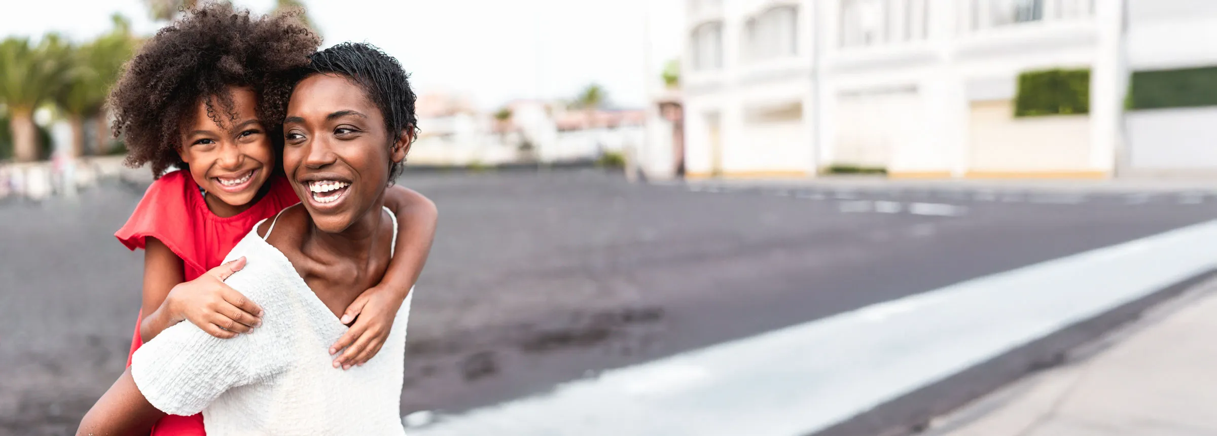 a woman giving a child a piggyback ride